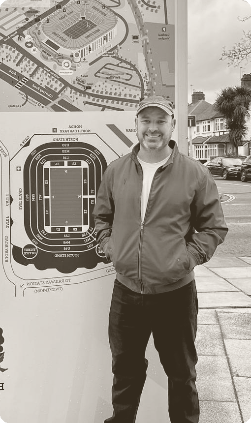 Ryan, founder of One Offer Forward, standing outside a stadium in London