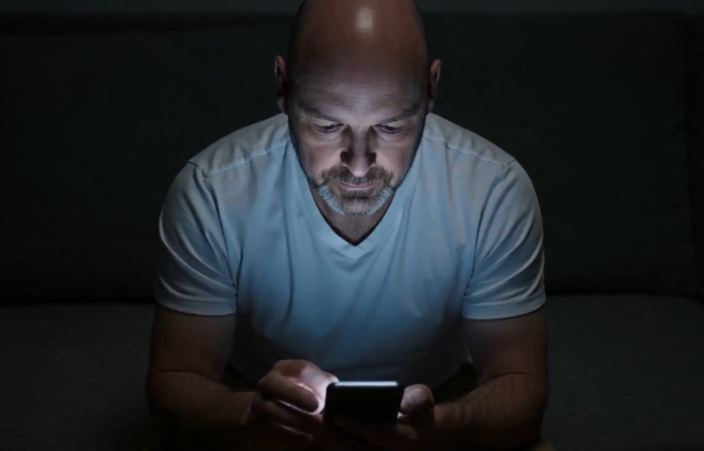 Scrolling on a phone late at night